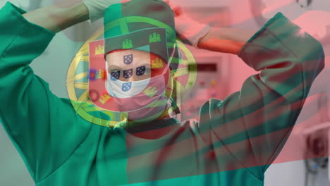 animation of flag of portugal waving over female surgeon in operating theatre