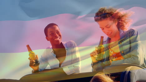 video compuesto de agitar la bandera alemana sobre dos chicas diversas bebiendo cervezas y hablando en el coche