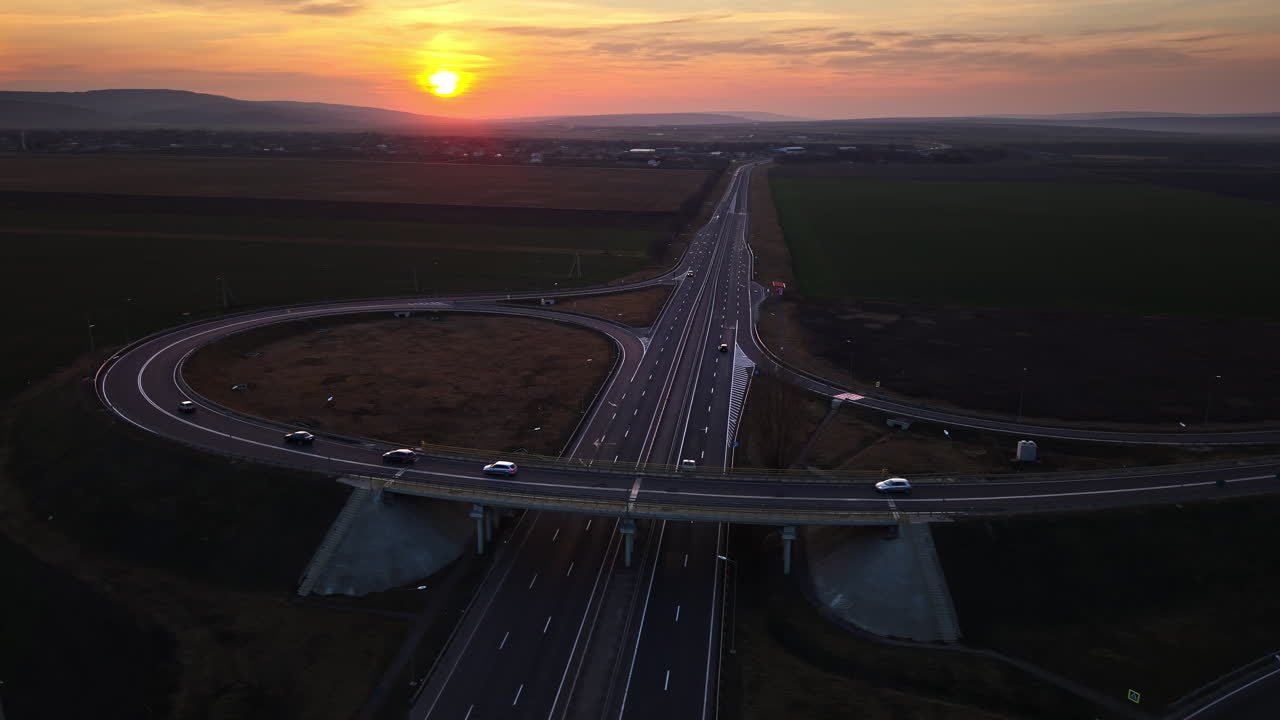 Aerial drone view of cars driving on the highway in Moldova at sunset