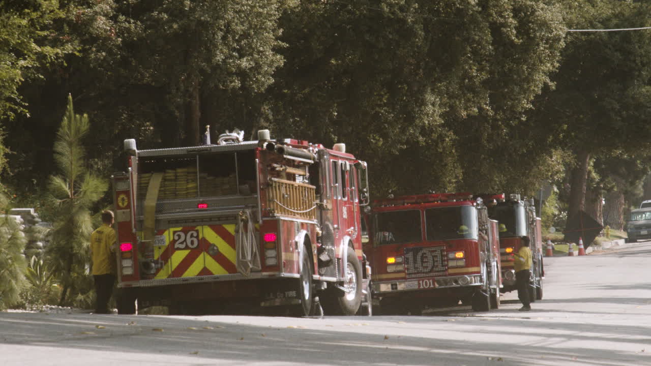 Fire Trucks and Firefighters on a Road
