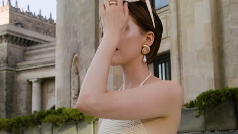 Front-view-of-elegant-woman-putting-the-sunglases-on