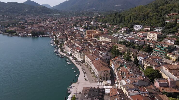 Vista aerea dell'idilliaco e soleggiato Lago di Garda e del lungolago della città di Salò, Lombardia, Italia, in una giornata estiva