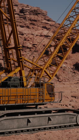 a yellow construction crane in the desert