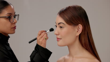 makeup artist applying makeup to a woman's face