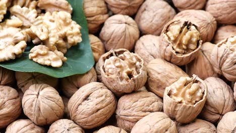 pile of walnuts with some halved