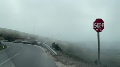 Dramatic-view-of-moving-clouds-over-curved-mountainous-roads