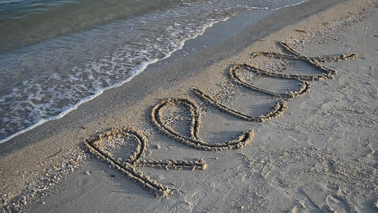 Inscription a relax on sand. Inscription on sand, the beach
