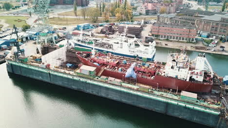 drone flying around cargo ship in the shipyard docks