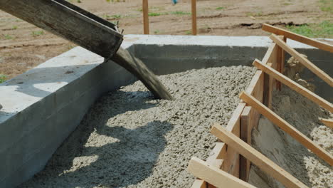 Work With Concrete At The Construction Site Workers Take Concrete Into A Wooden Mold Heavy Manual La