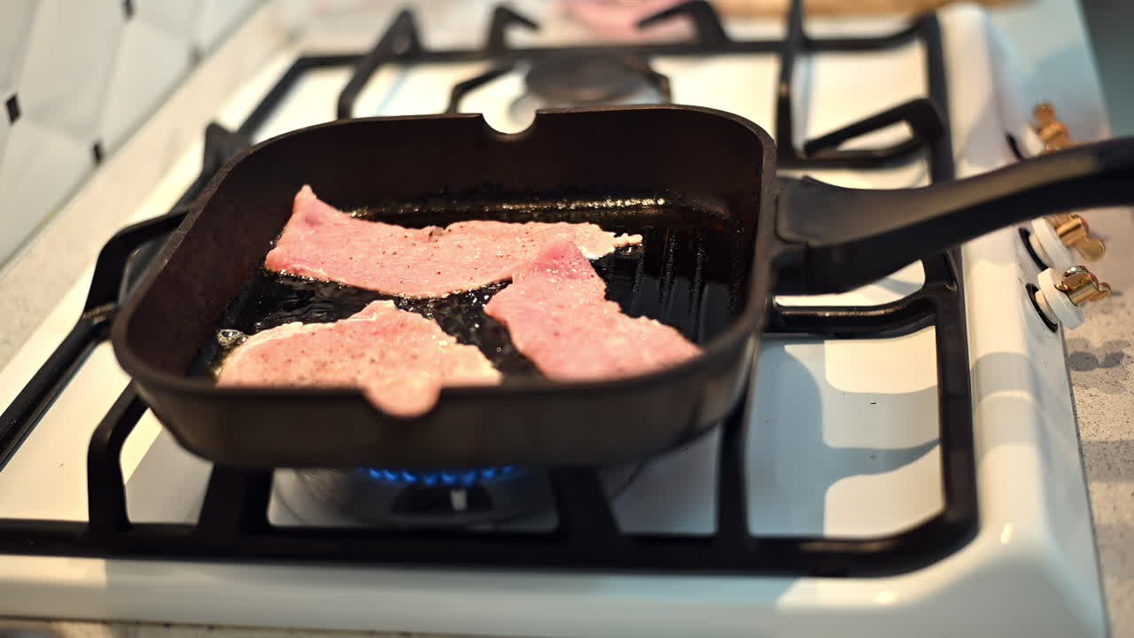 Sizzling bacon is frying in a black pan on the stove. The kitchen is bright and inviting, creating a warm atmosphere for cooking and enjoying breakfast