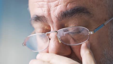 close-up of old man with problem in his eyes.