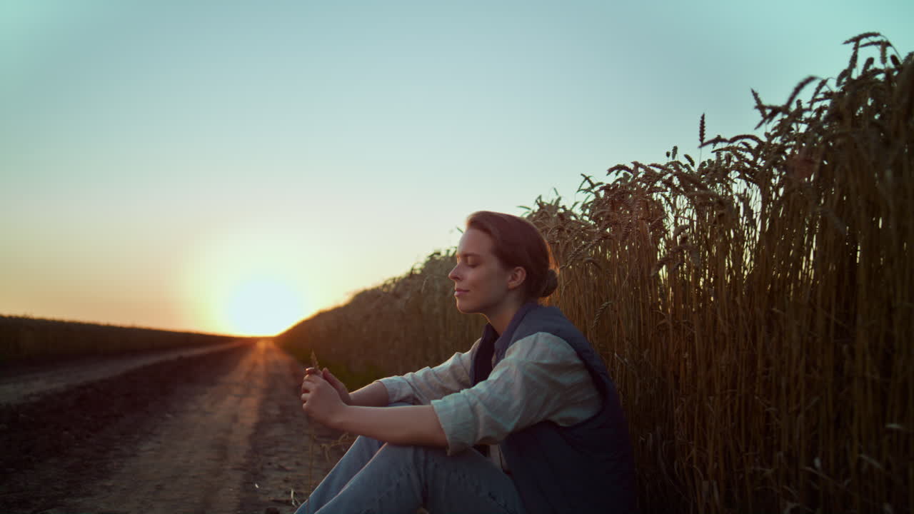 Portrait smiling farmer golden summer sunset. Tired agrarian resting alone.