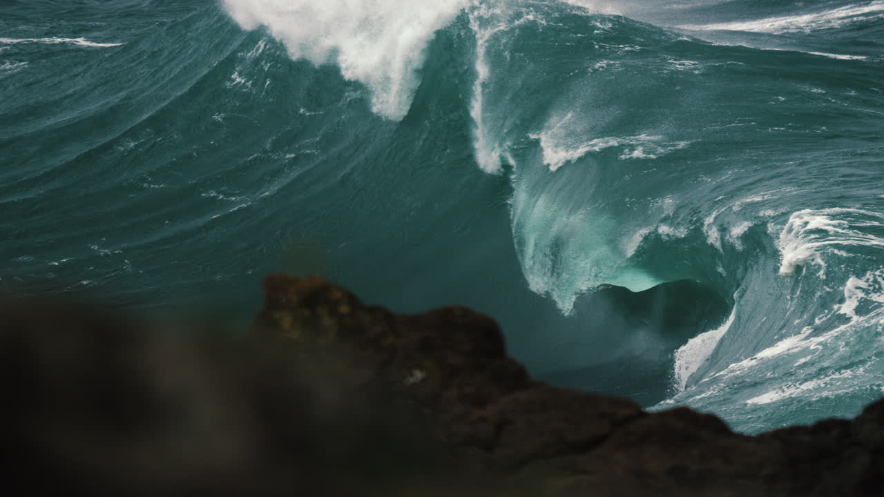 Heavy wave breaking behind the rocks