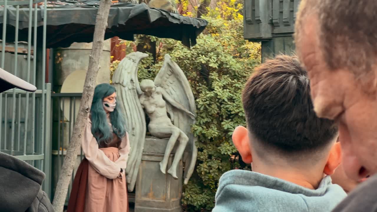 Group of people lining up to enter the haunted house at the Fantasilandia amusement park in Santiago de Chile, horror decorations, actors