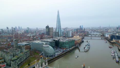 orbital right to left drone shot of the shard and the city hall of london, england