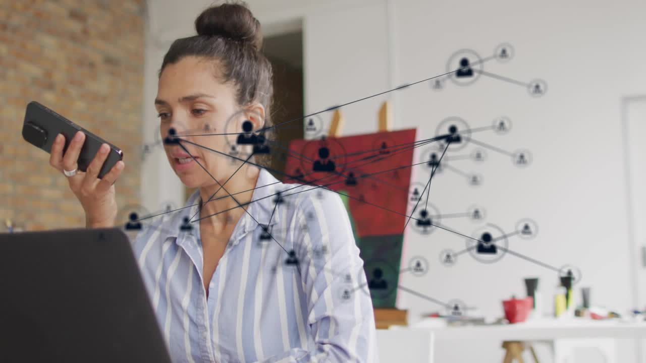 Woman speaking into phone, using laptop for business, animated nodes and icons crossing over her