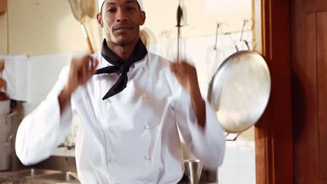 portrait of happy chef standing with arms crossed