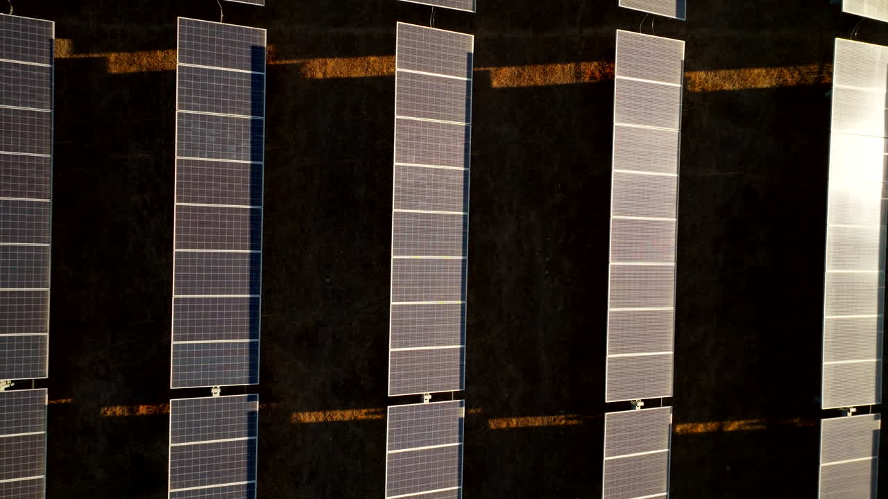 Closeup top down riser over zero emissions PV panels on solar park