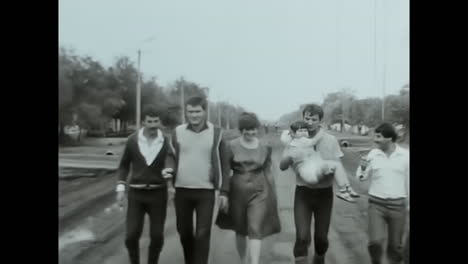 group of men walking together on a soviet street during the ussr era. circa ussr 1980s: a group of men, representing the soviet people during the ussr era, walking down a street in a classic archive