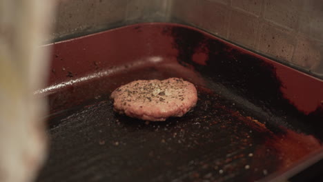 meat patty cooking in a pan at the fast food restaurant