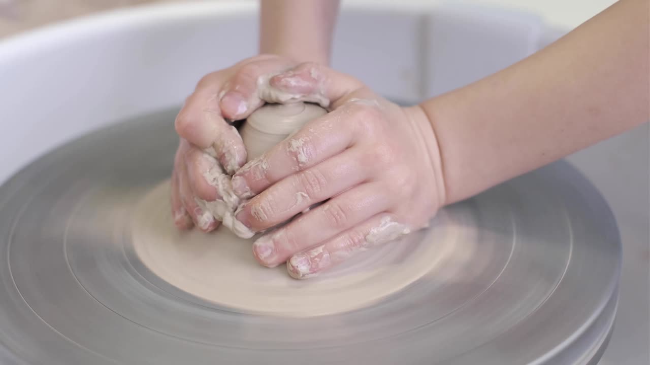 un niño trabaja con arcilla en la rueda de un alfarero. concepto de un taller creativo.