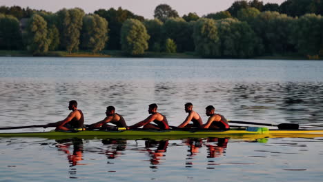 rowing competition on a lake at sunset