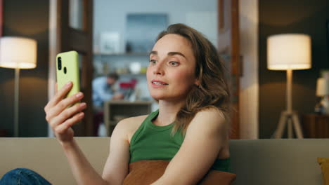 Closeup-positive-girl-waving-hand-calling-cellphone-home.-Lady-greeting-friend