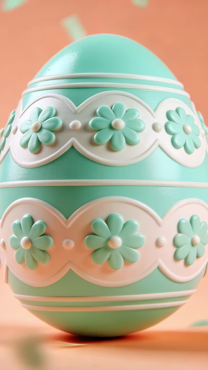 Vertical video: Confetti falling causing pan as teal egg rotating on peach wall, revealing bands