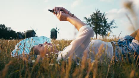 woman in the summer park using mobile phone. authentic creative shot