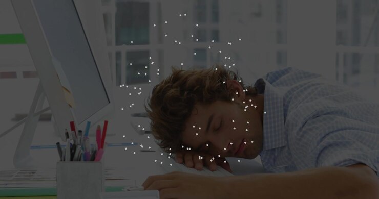 Sleeping at desk, man surrounded by floating white particles in animation