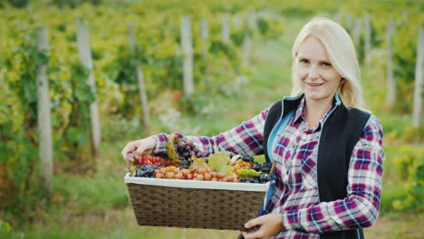 Portrait-Of-An-Attractive-Farmer-With-A-Basket-Of-Grapes-Smiles-Looks-Into-The-Camera