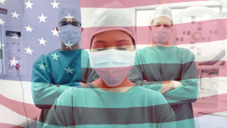 animation of flag of usa waving over surgeons in operating theatre