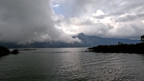 Vapor-clouds-rolling-over-lake-in-Kintamani,-Bali,-in-evening-dusk