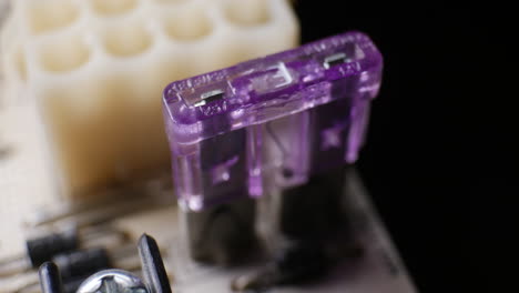 a 3 amp fuse on a circuit board with other electronic components macro close up