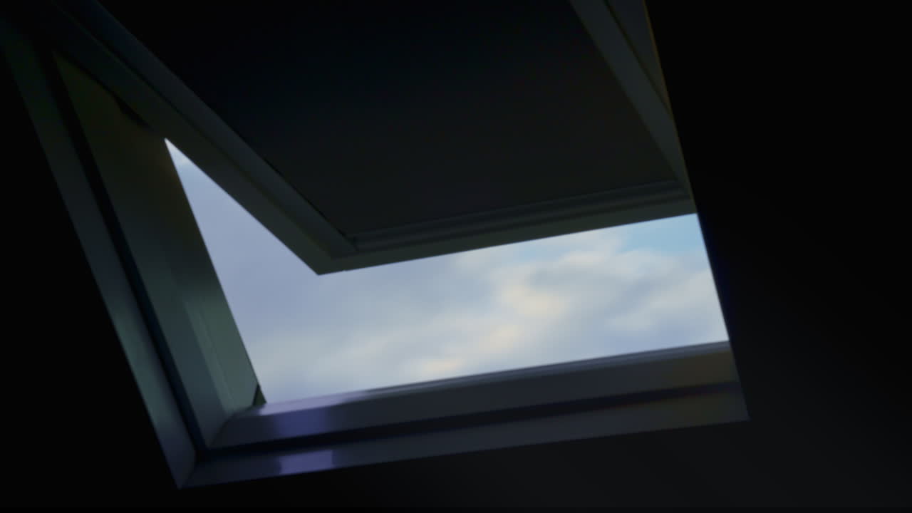 Clouds pass by in the evening, seen through the roof window.