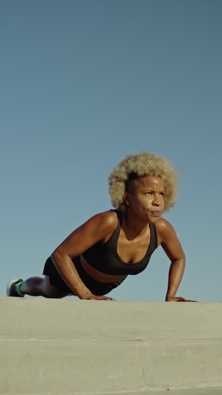 Woman doing push-ups outdoors