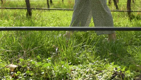 Tight-shot-of-a-girls-feet-walking-through-a-vineyard-in-slow-motion