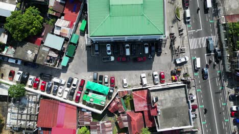 top-down view of full parking lot in southeast asian town area with rooftops and busy streets in albay, philippines