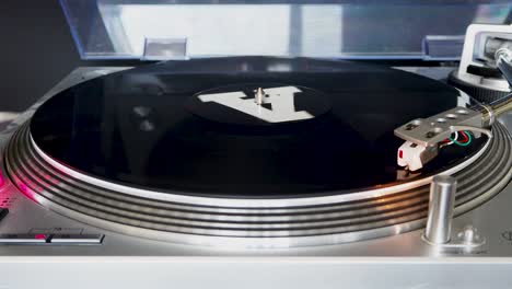 close up, modern turntable with rotating vinyl record, dj gear, equipment, a-side played