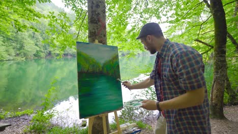 The-painter-paints-landscapes-on-his-canvas.