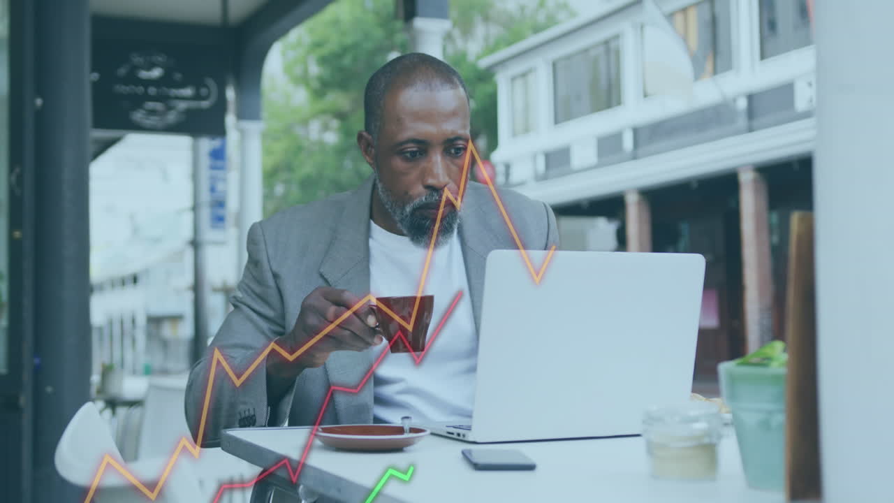 Animation of financial data processing over african american businessman using laptop