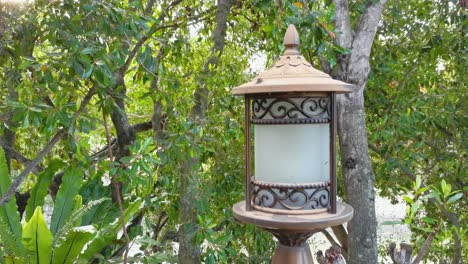 an outdoor garden lantern with patterns made from metal and frosted glass