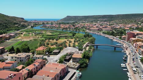 Temo-River-flows-through-Bosa-to-the-sea-at-Sardinia,-Italy---4k-Aerial