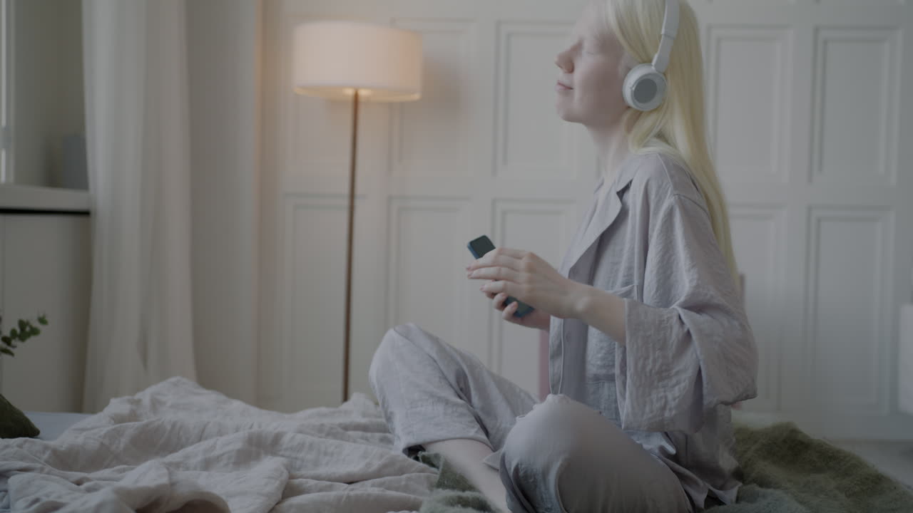 Woman Listening to Music in Pajamas