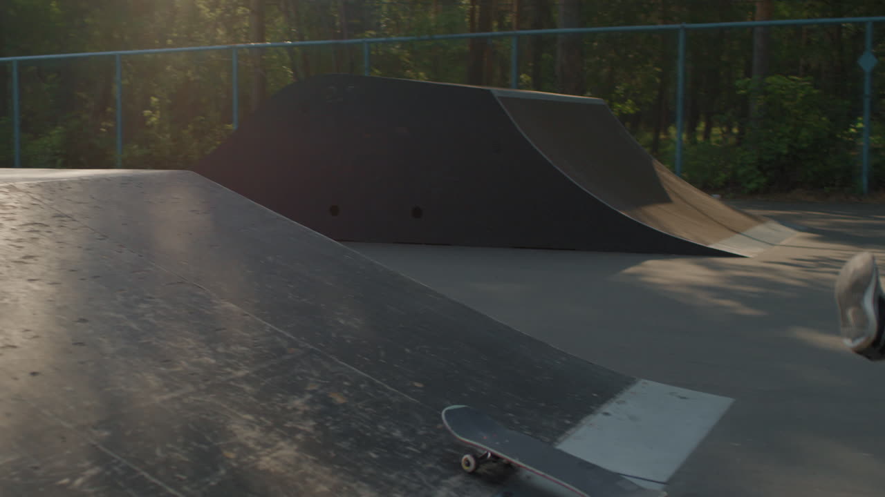 Slowmo of Skater Jumping Over Ramp and Falling