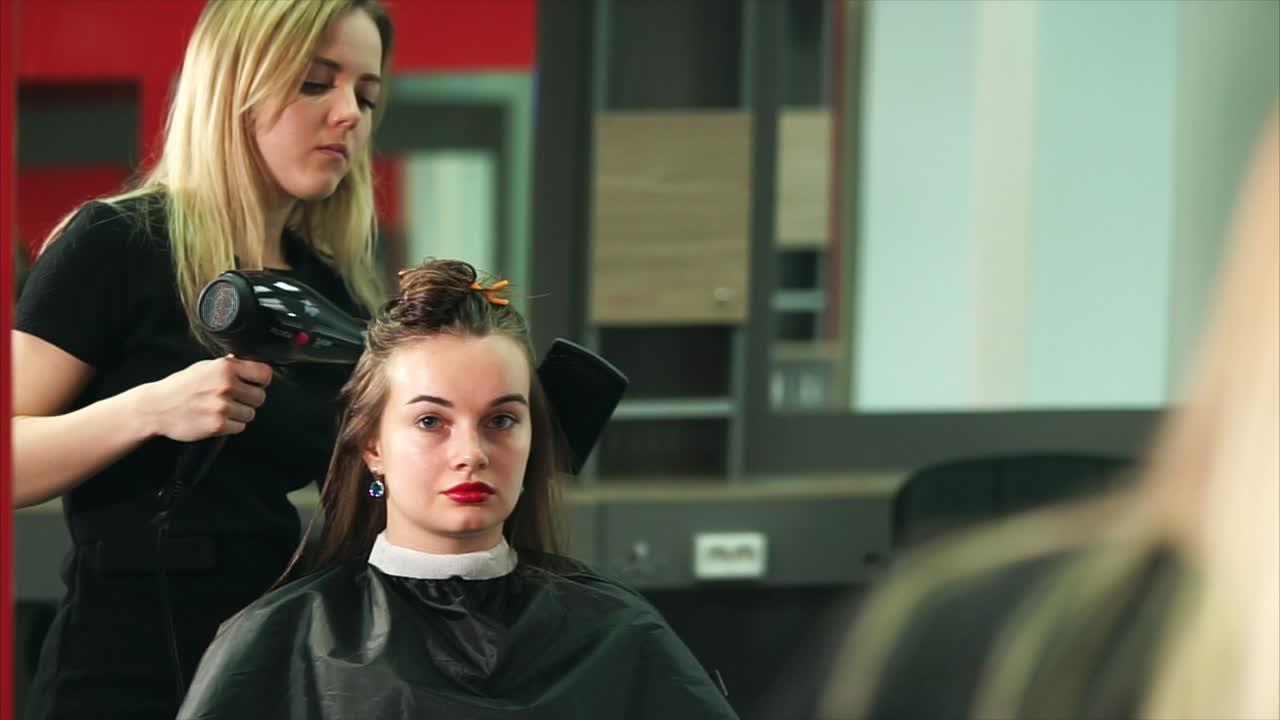 Woman getting her hair styled at a hair salon