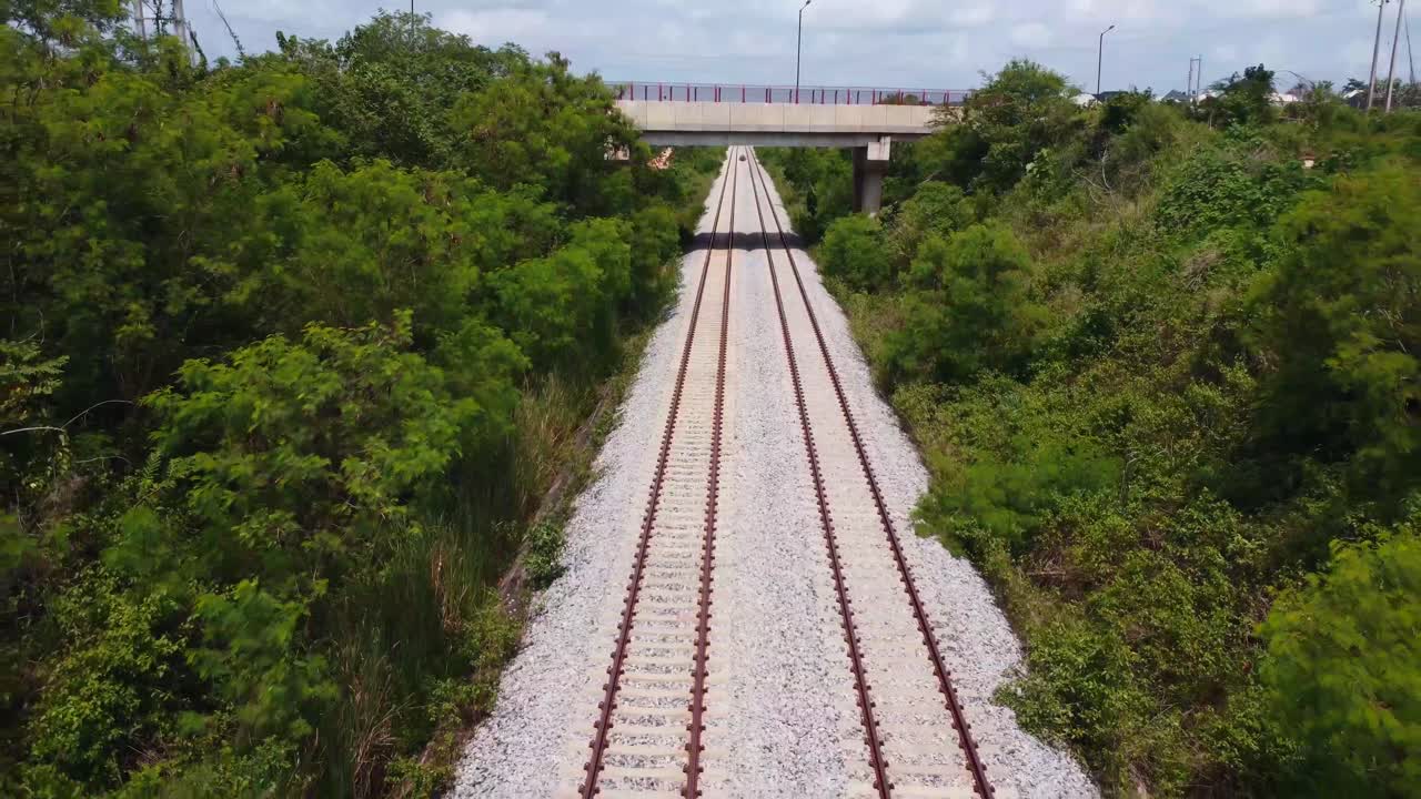 Lagos-Ibadan railway line seen from above, zooming out as it cuts through dense green landscape in Oyo state.
