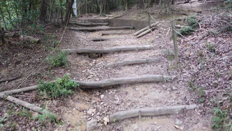 pov hiking on wooden stairs uphill mount daimonji in kyoto japan, rocky road