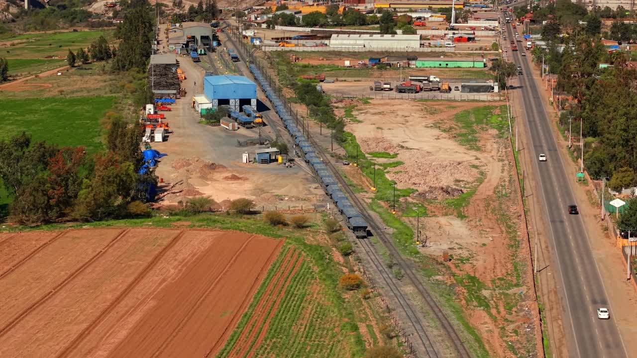Telephoto drone shot around an old mining train, in sunny Vallenar city, Chile