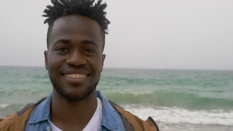 Front-view-of-African-American-man-standing-on-the-beach-4k